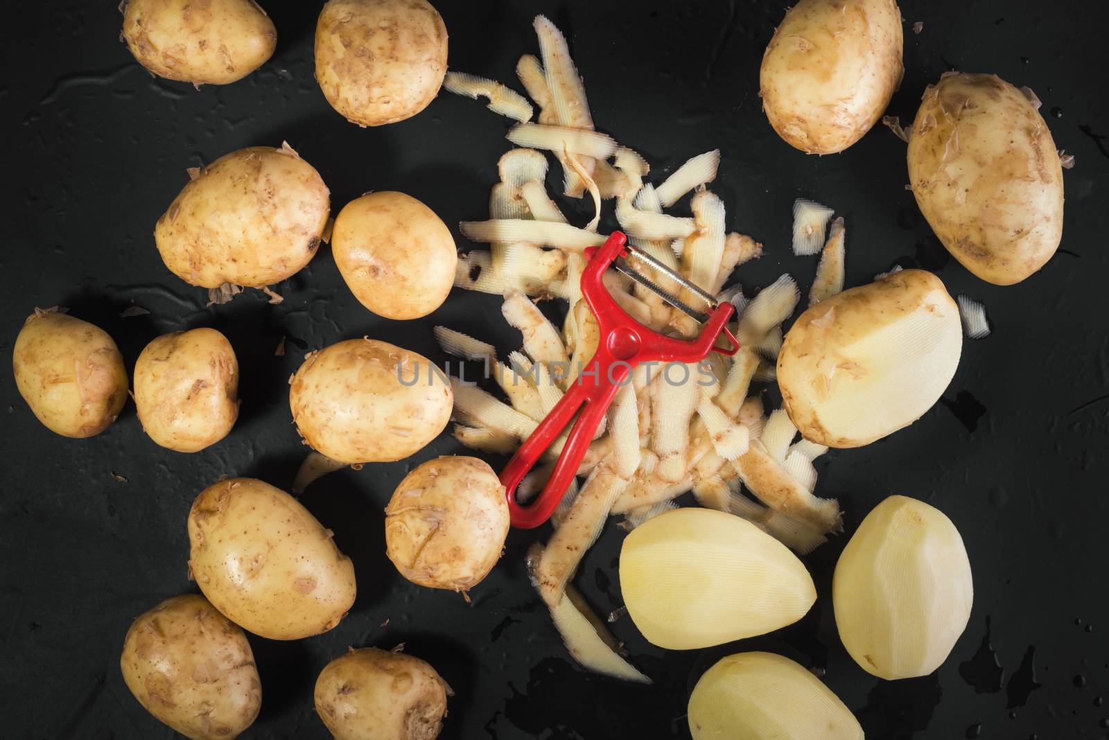peeled potatoes, Vegetable peeler, raw potatoes and potato peels on black background, cooking potatoes