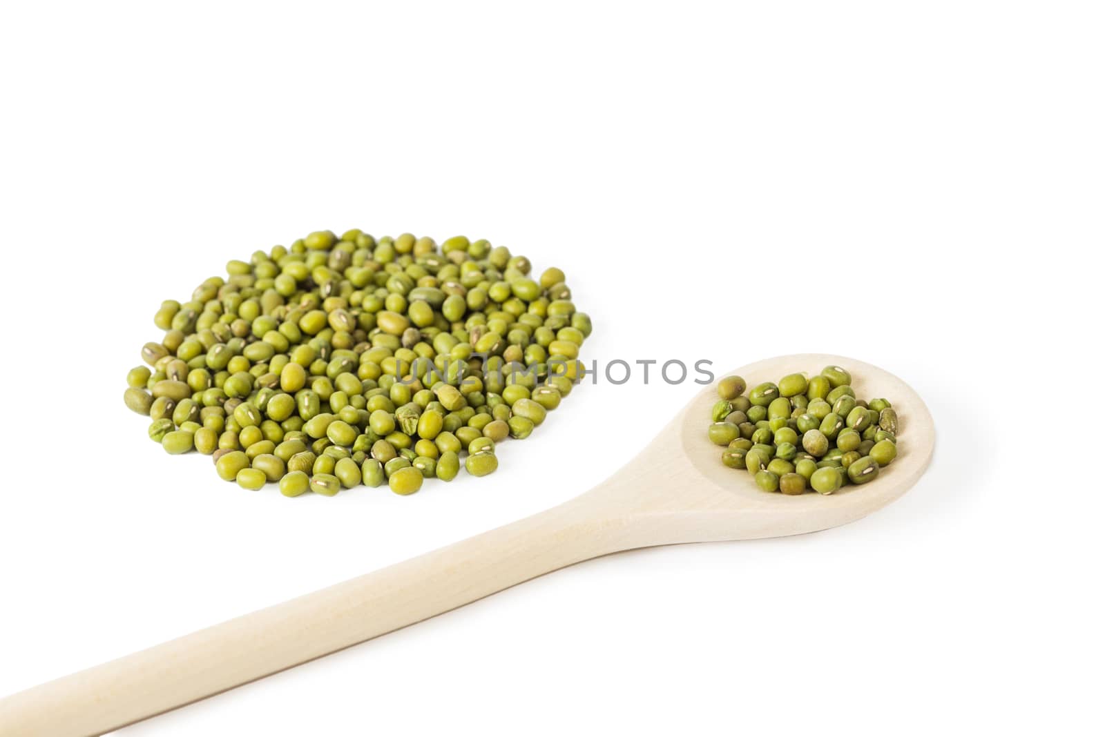 a pile of Raw mung beans Vigna radiata, and mung beans in wooden spoon isolated on white background