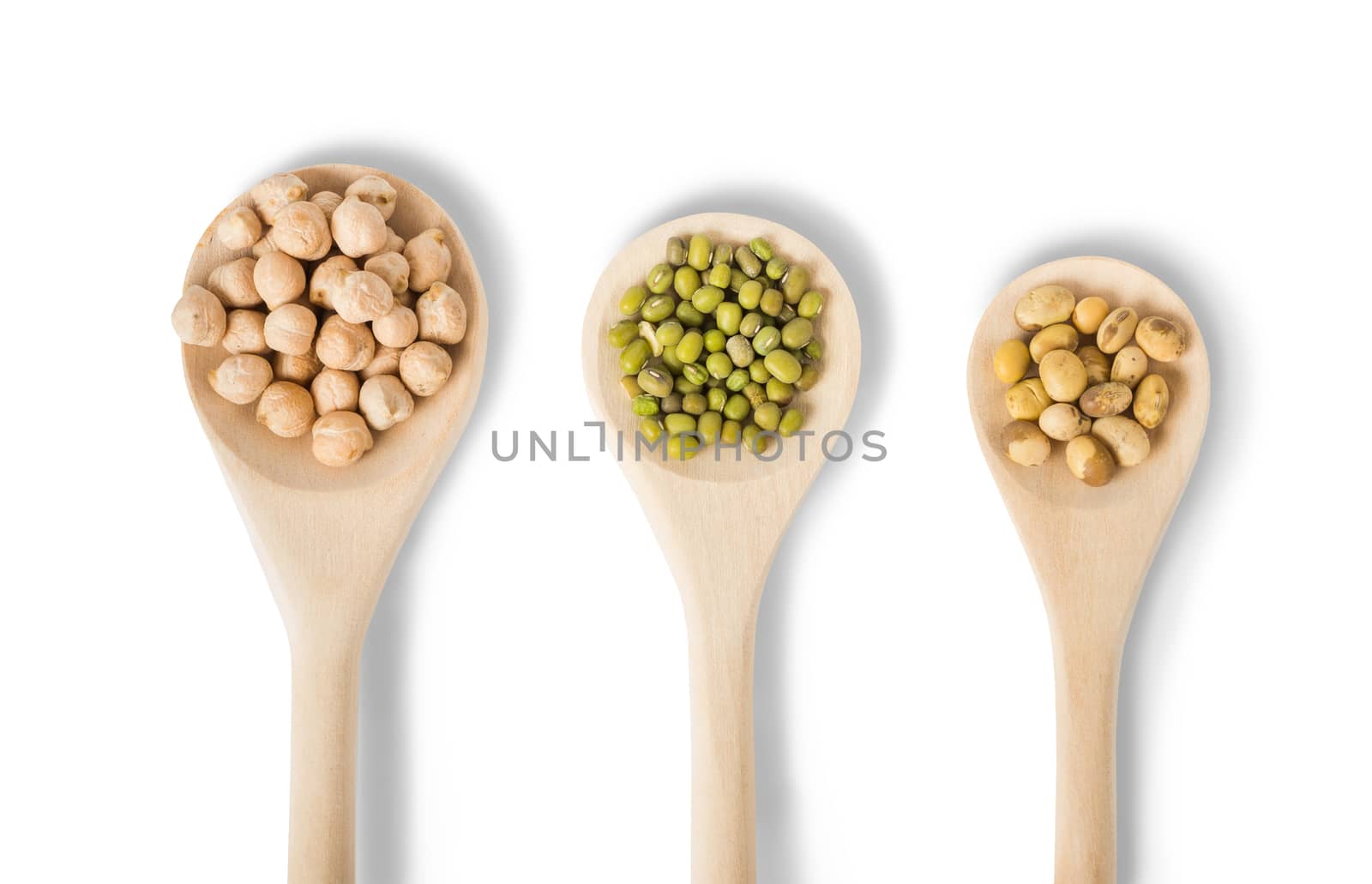 Different types of legumes in a wooden spoons isolated on white background: soybeans, mung beans and chickpea 