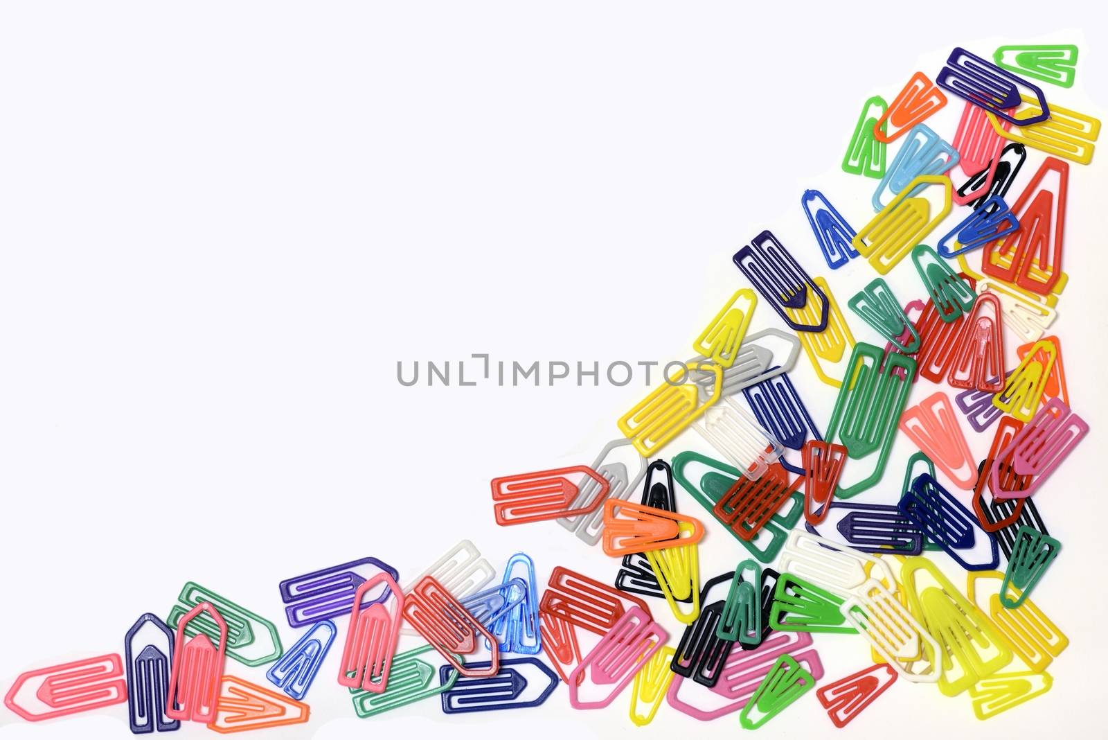 Close-up of multi-colored paper clips on a white background.