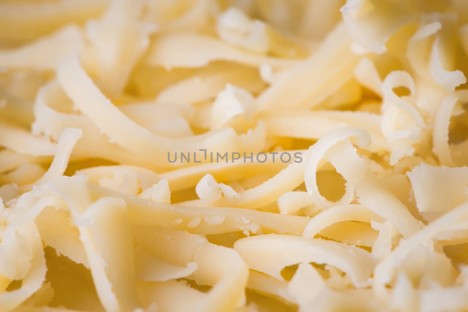 Grated fresh cheese close up, ingredient for pizza