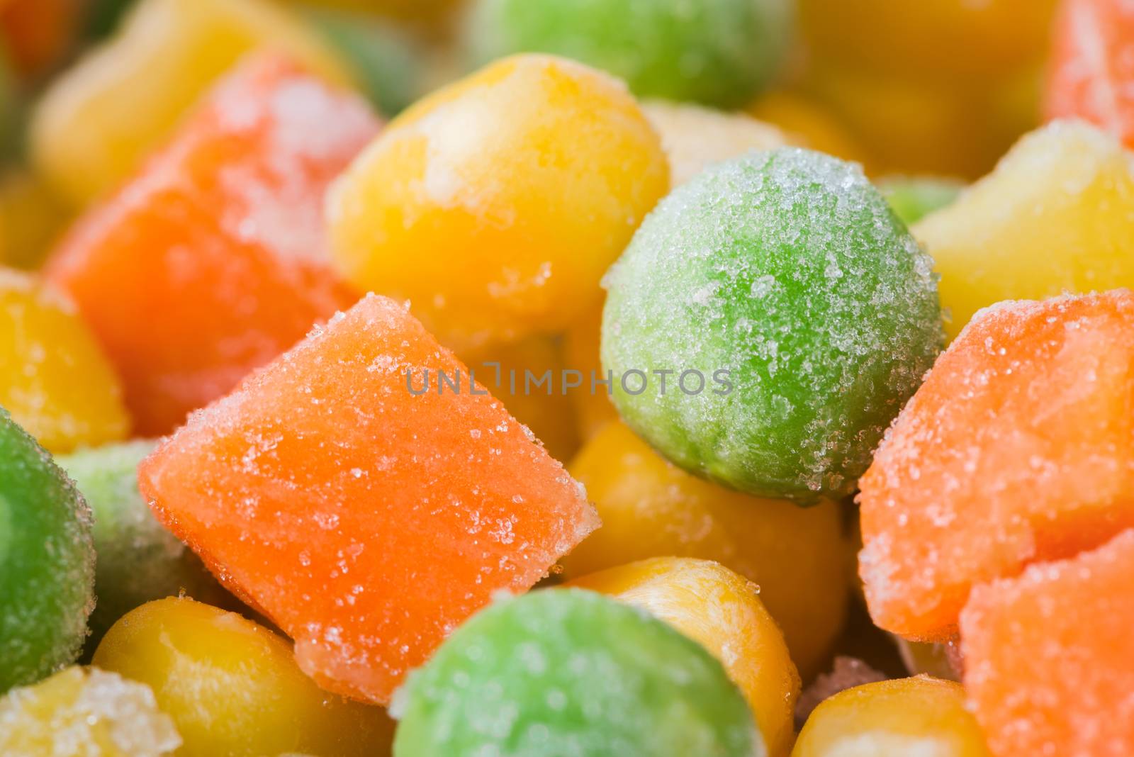 Frozen vegetables and legumes, corn, green peas, chopped carrots as food background, close up