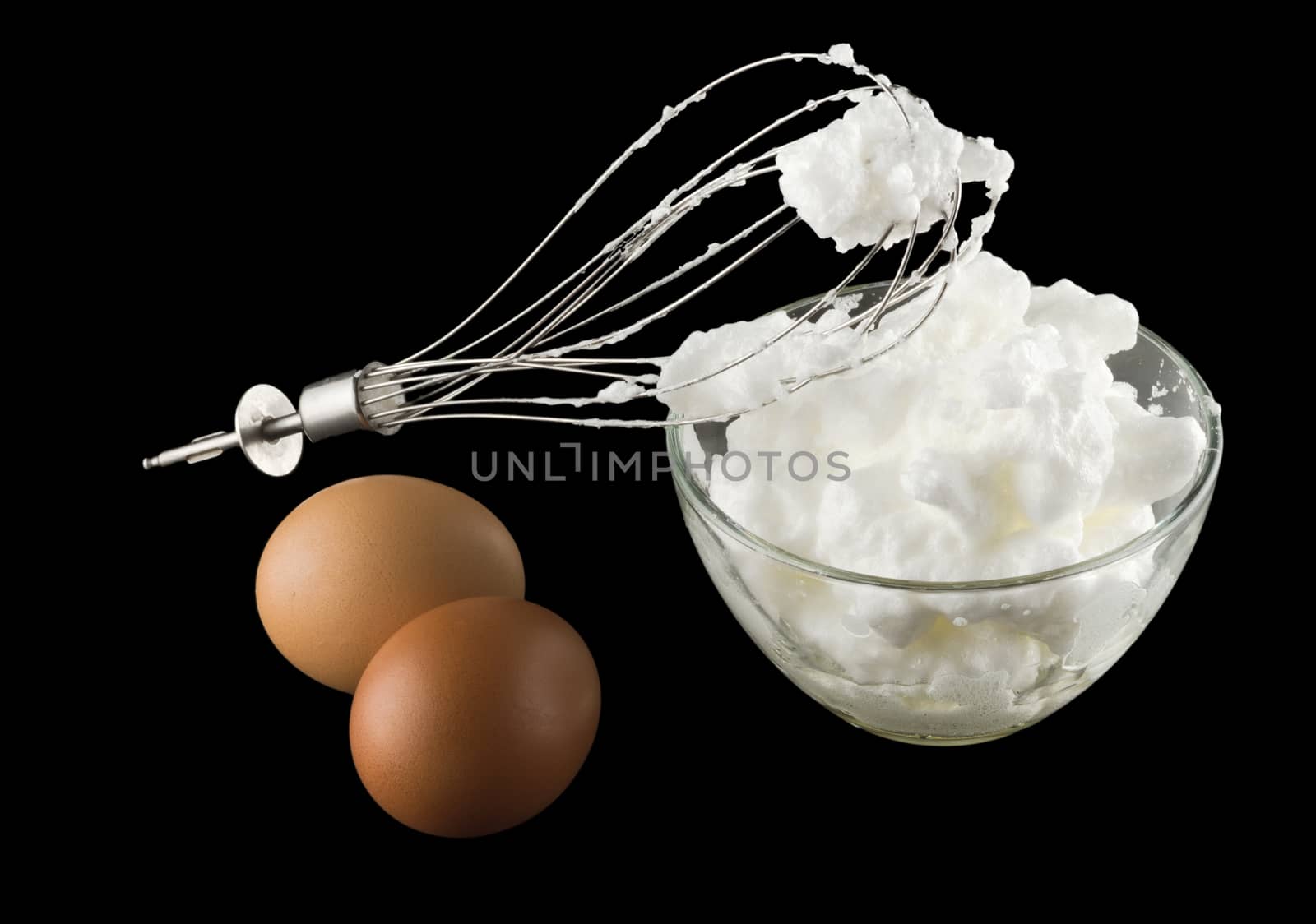 whipping eggs  for cream with whisk and eggs Isolated on black background