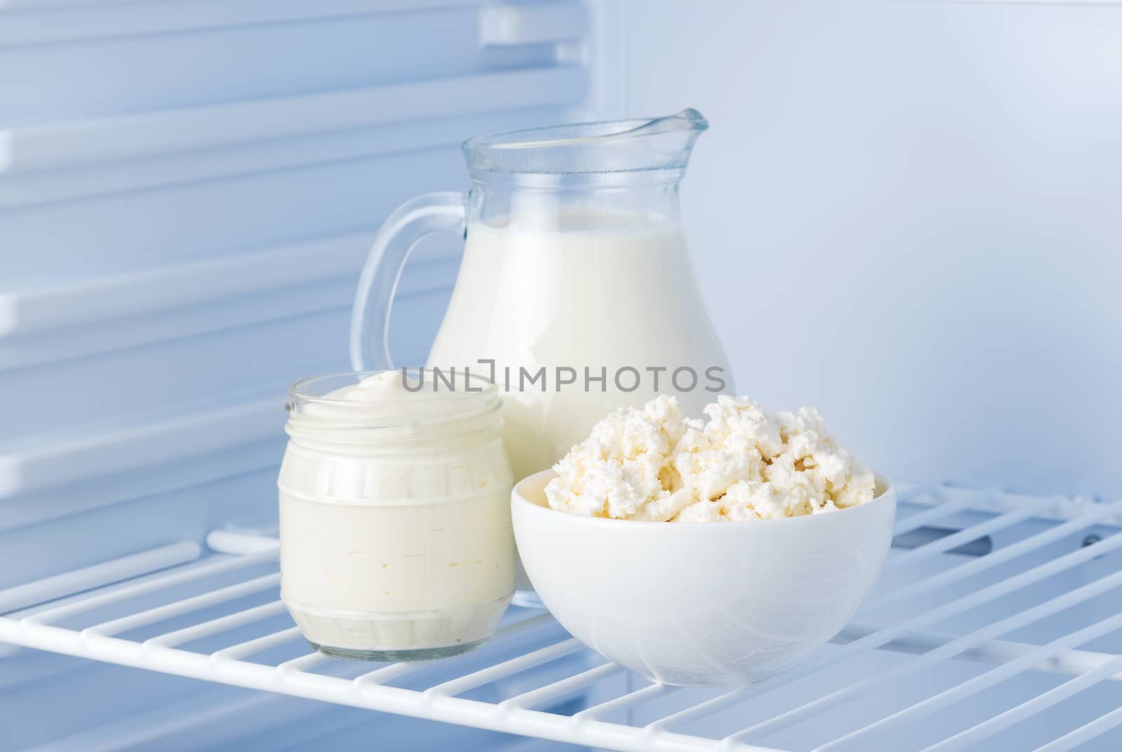 tasty and healthy dairy products in the refrigerator: sour cream, cottage cheese and milk