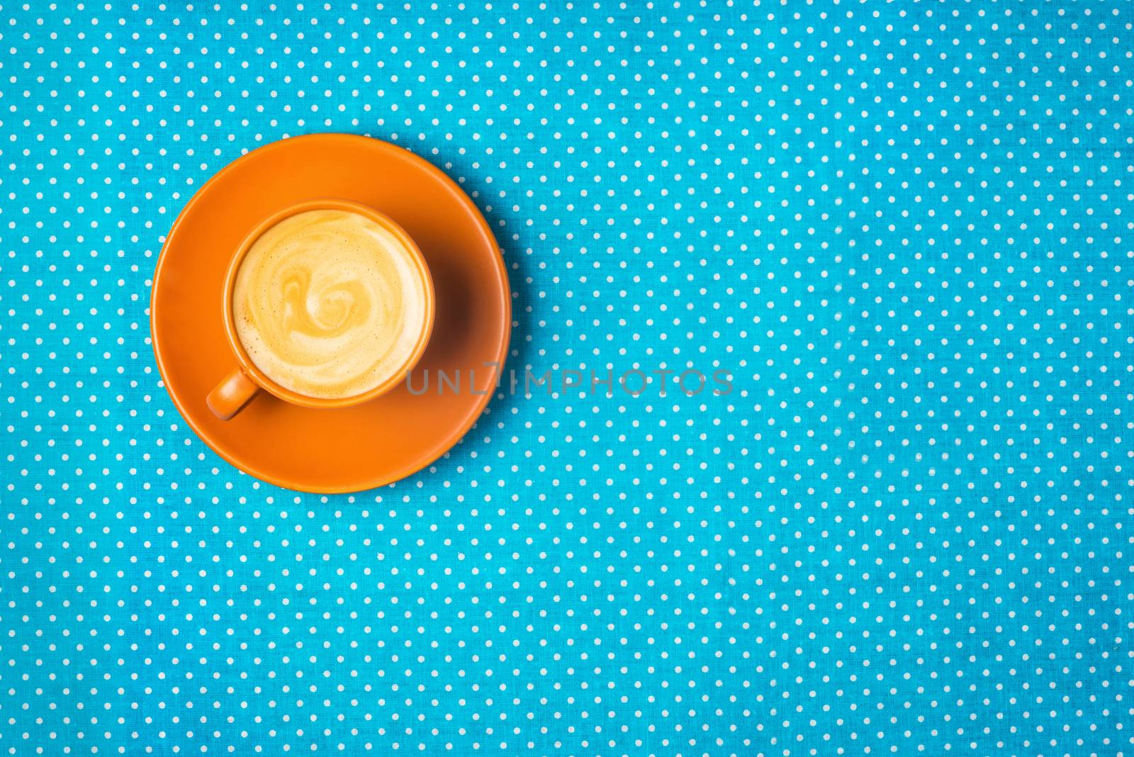 ceramic cup with coffee  espresso on a bright blue background, top view