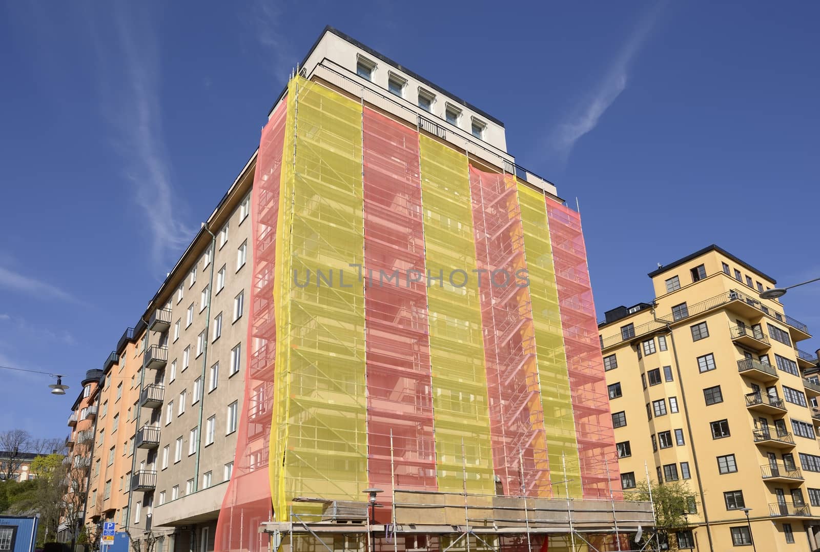 Thermal insulation being installed with scaffolding around the building