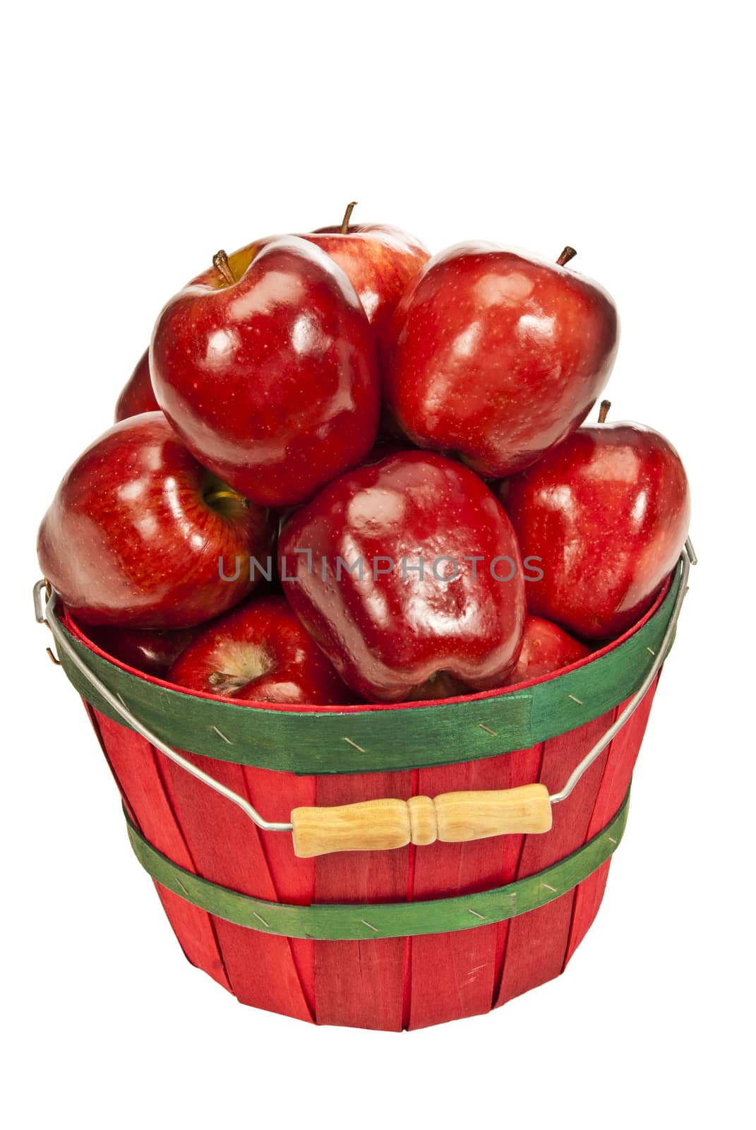 Vertical shot of a little red basket full of delicious red apples.  On white background