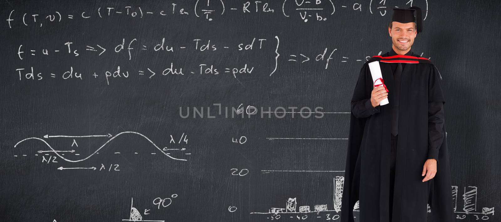 Charming graduate boy with his diploma  against blackboard