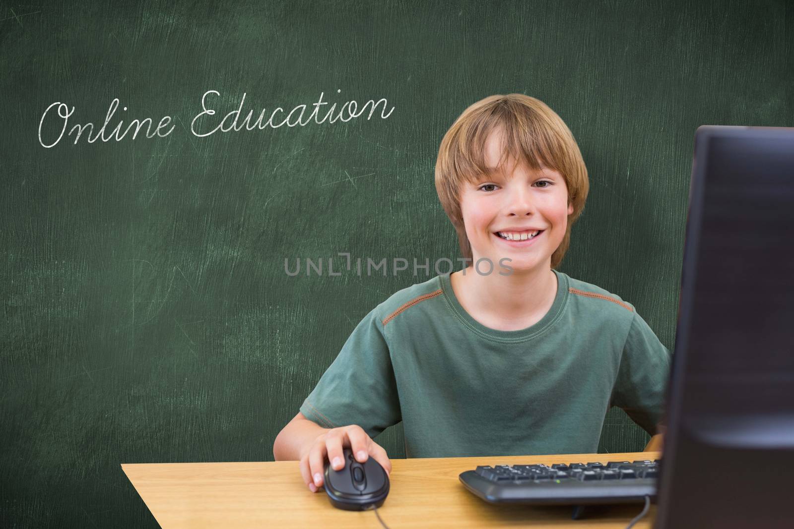 The word online education and school kid on computer against green chalkboard
