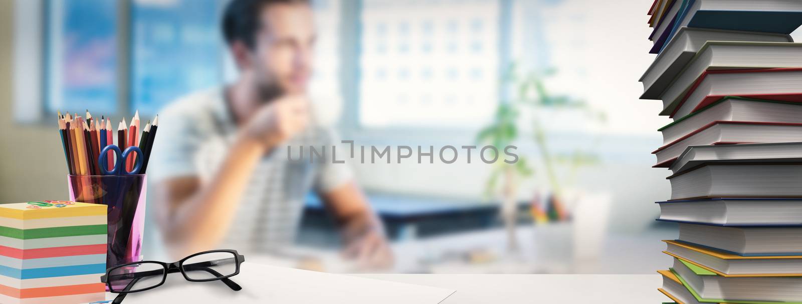 Students desk against casual businessman drinking coffee at his desk