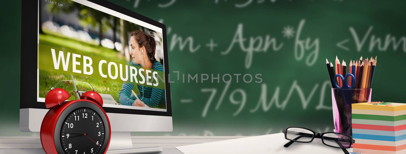 Computer screen against green chalkboard
