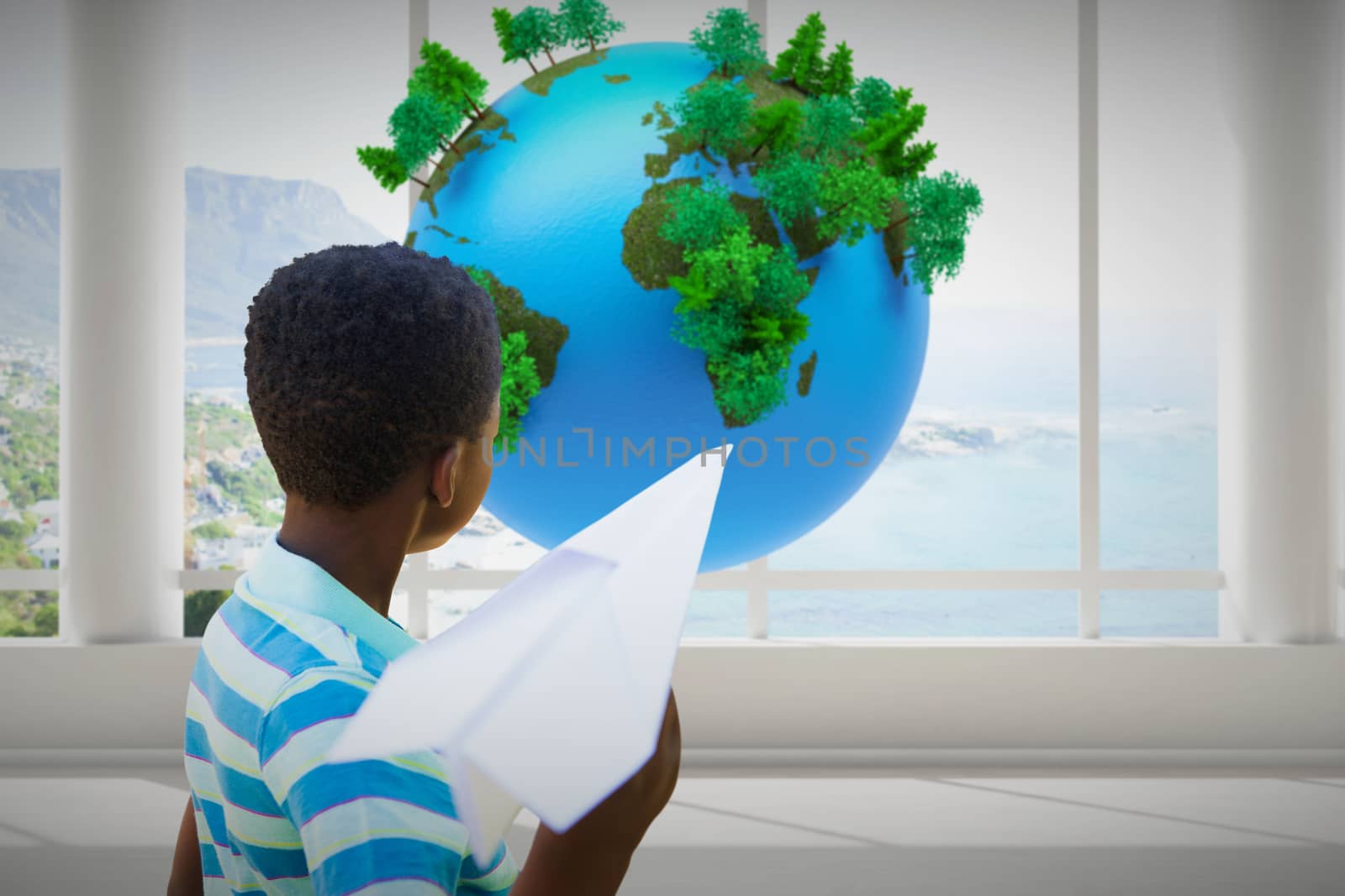 Cute little boy with paper airplane against earth floating in room