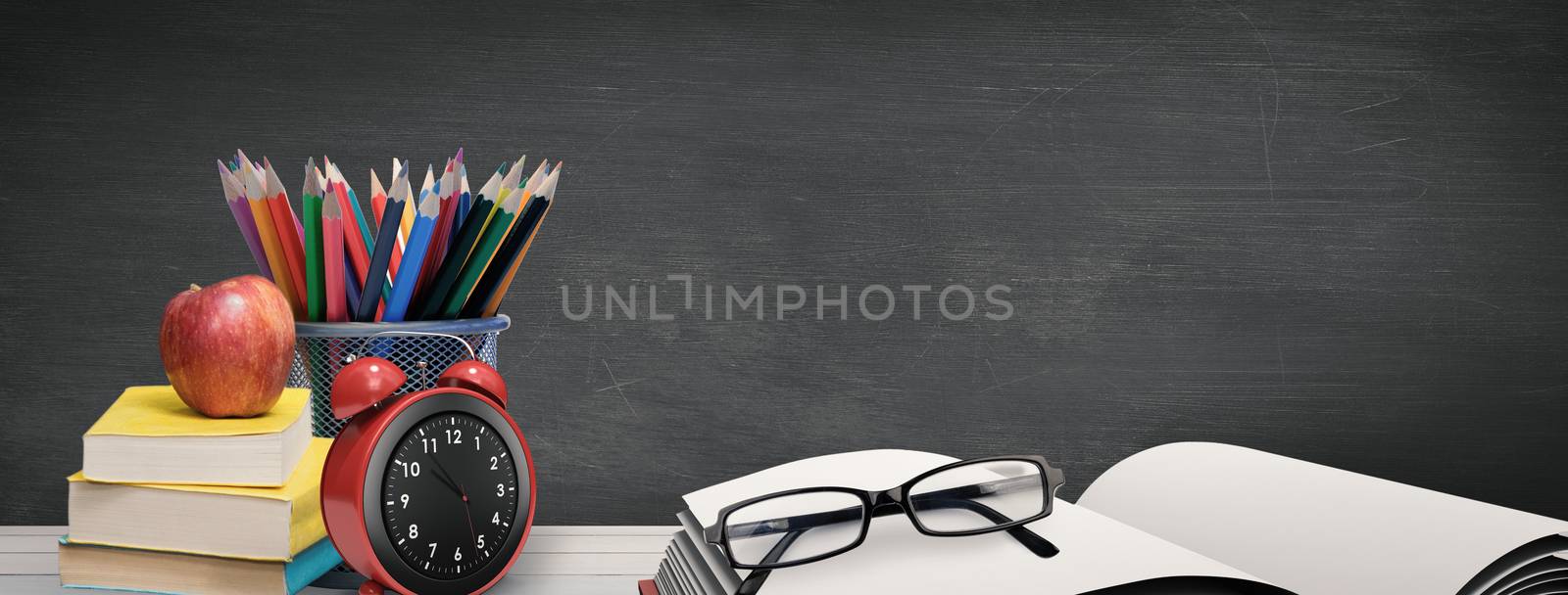 Composite image of school supplies on desk by Wavebreakmedia