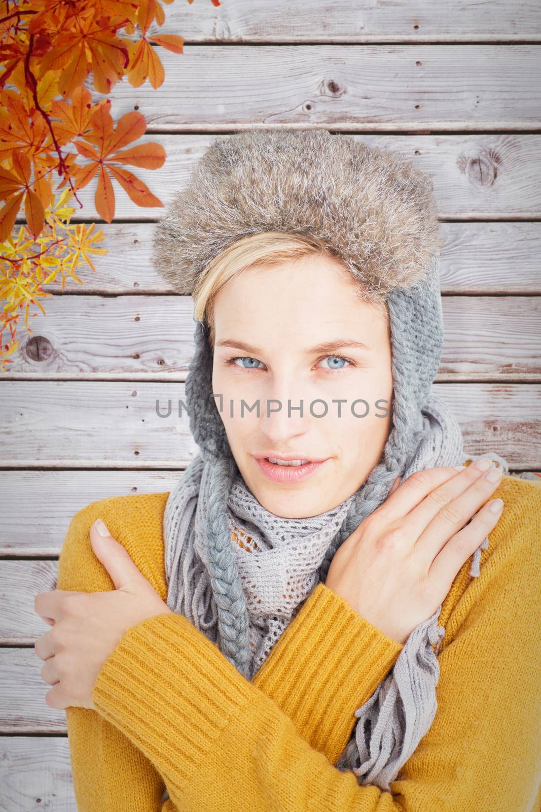 Composite image of woman in winter clothes shivering over white background by Wavebreakmedia