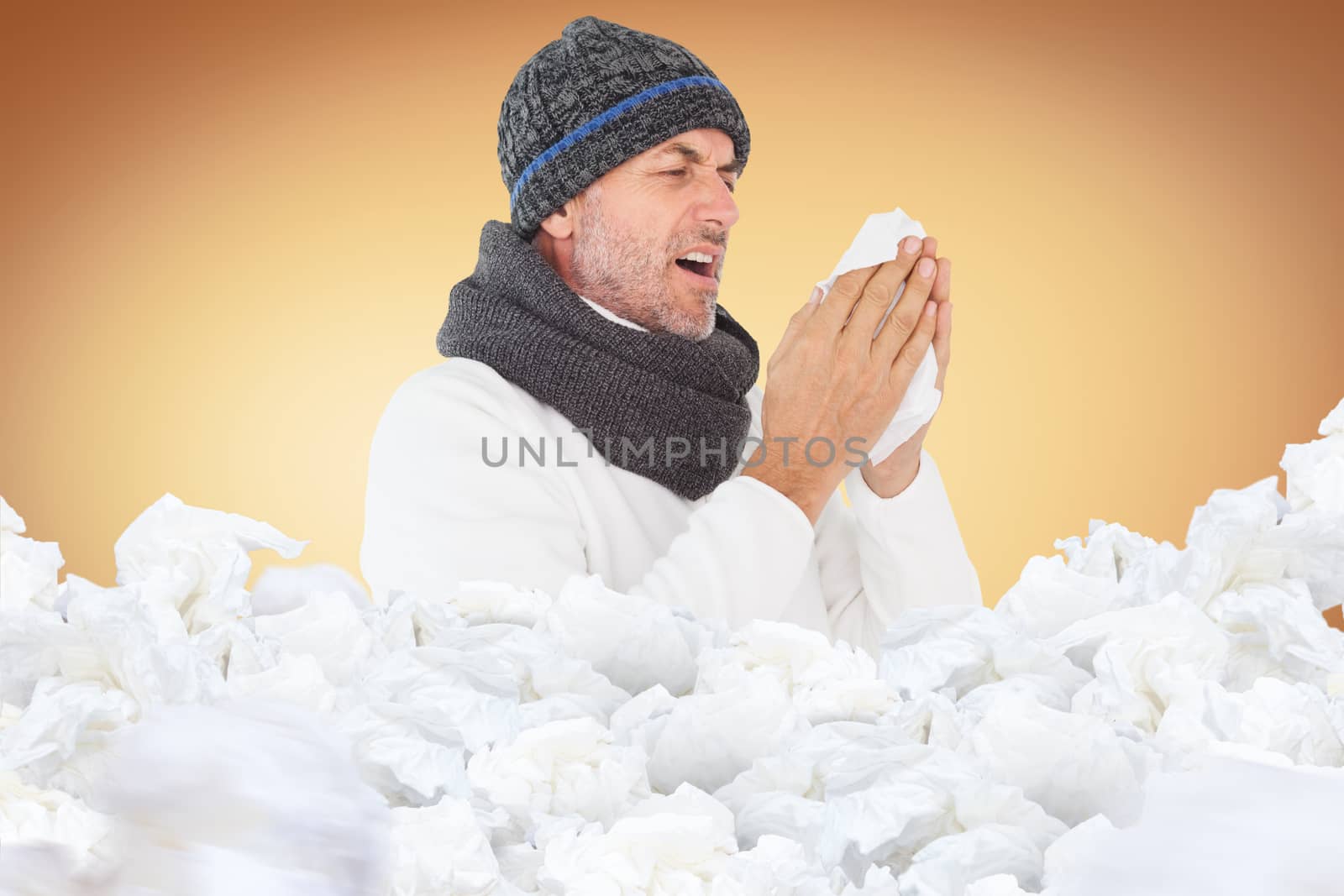 Sick man in winter fashion sneezing against orange vignette
