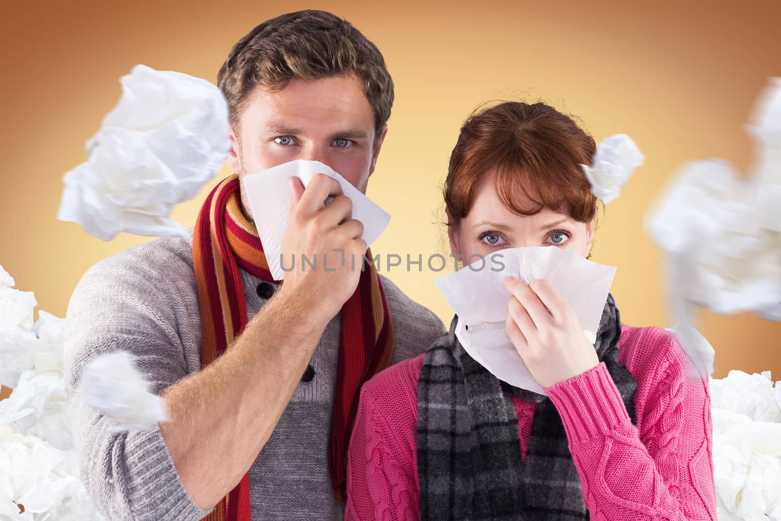 Couple blowing noses into tissues against orange vignette