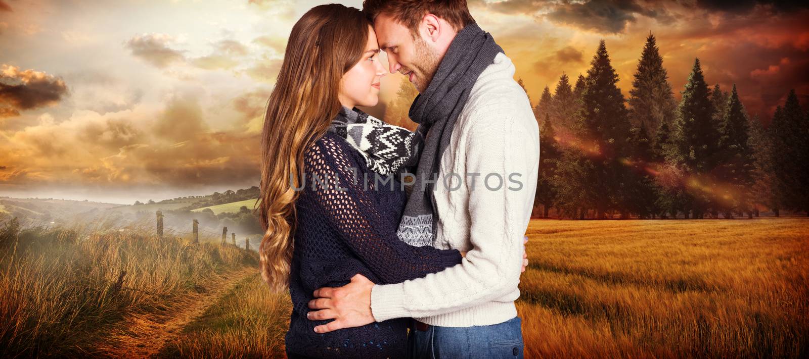 Side view of young couple embracing against country scene