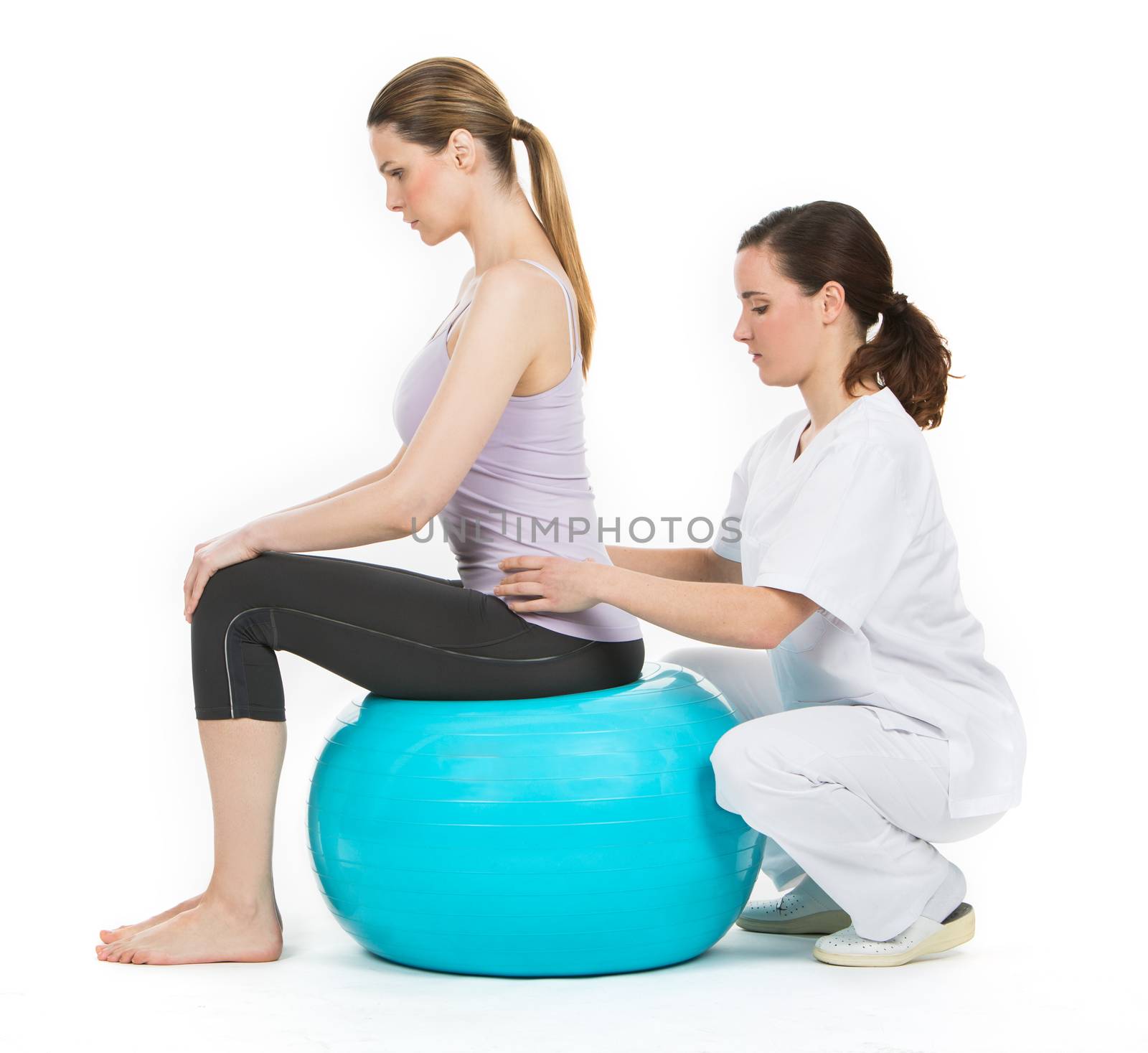 doctor with medical ball and woman patient by Flareimage
