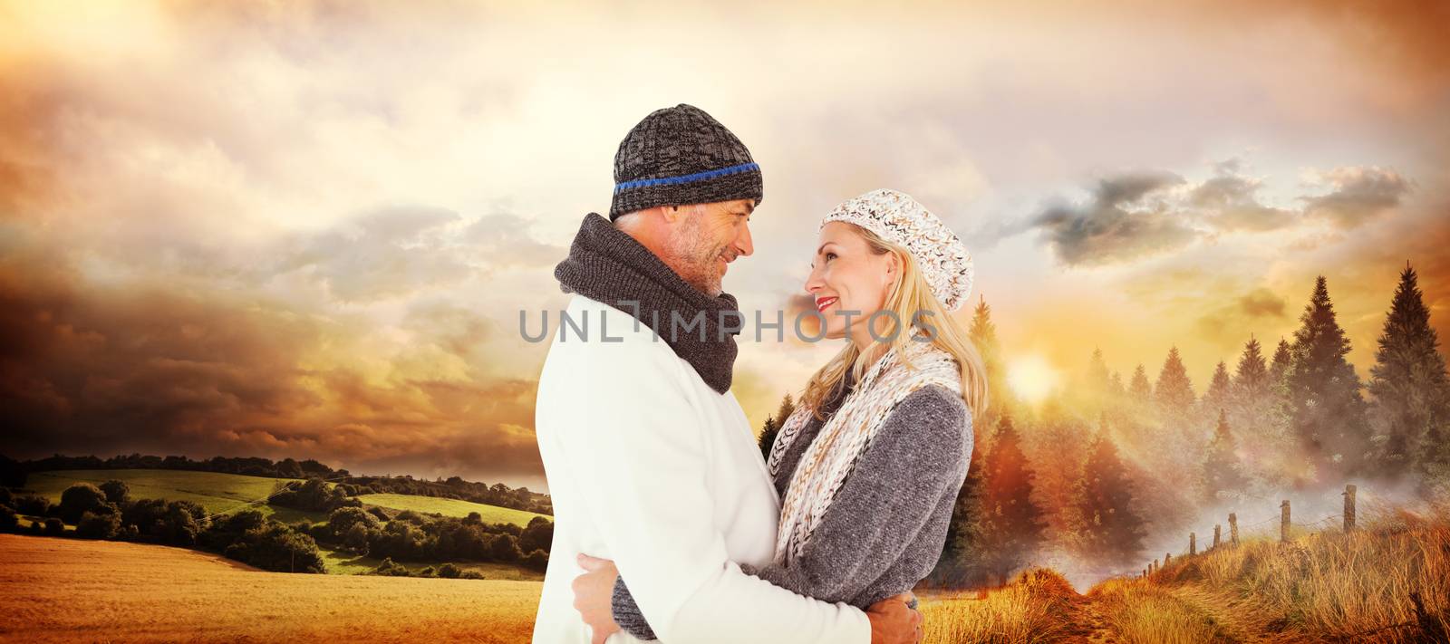 Composite image of happy husband holding wife while looking at each other by Wavebreakmedia