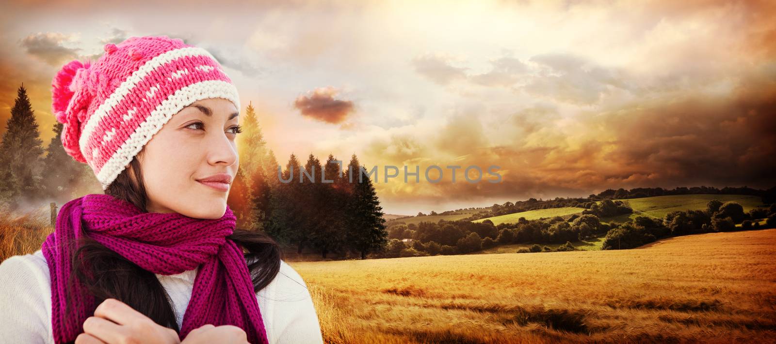 Pretty brunette in winter clothes against country scene