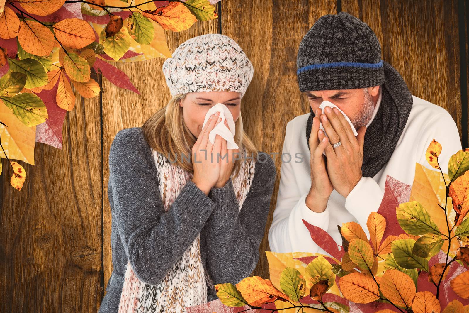Couple sneezing in tissue against wooden table