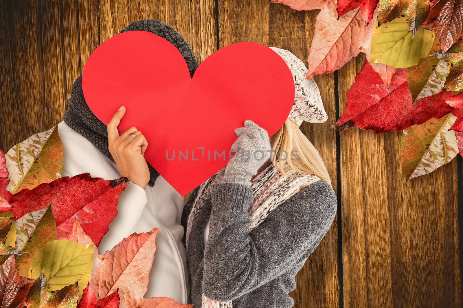 Composite image of couple behind red heart by Wavebreakmedia