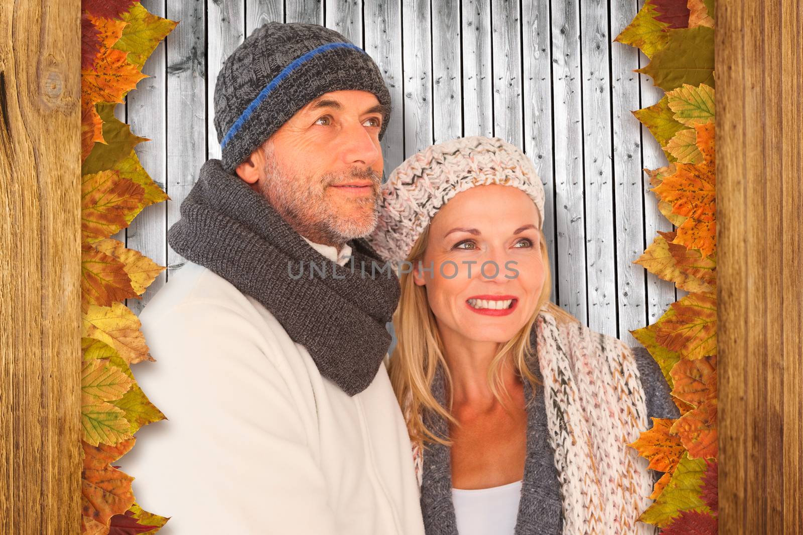 Composite image of cheerful couple in warm clothing by Wavebreakmedia