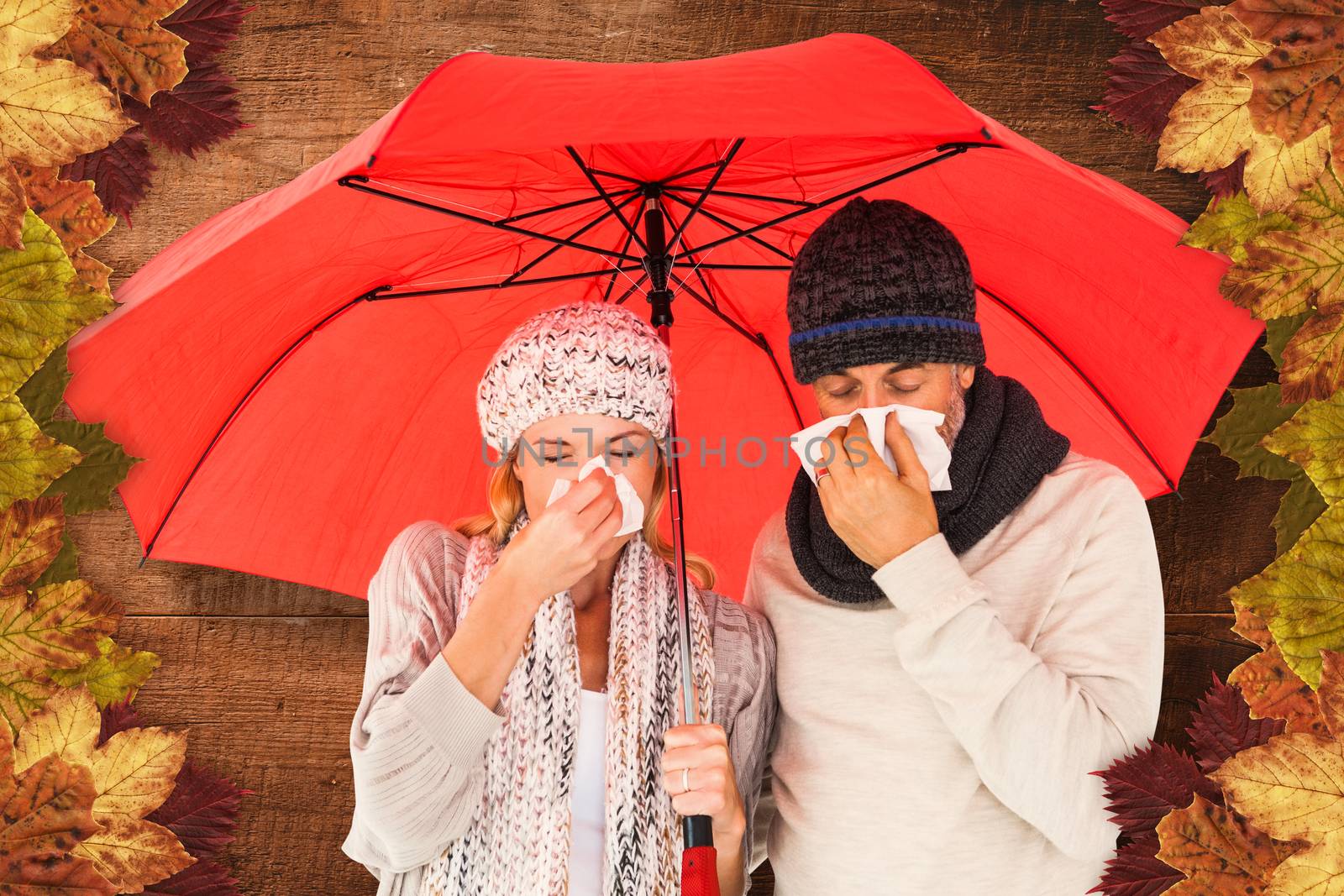 Ill couple sneezing in tissue while standing under umbrella against overhead of wooden planks
