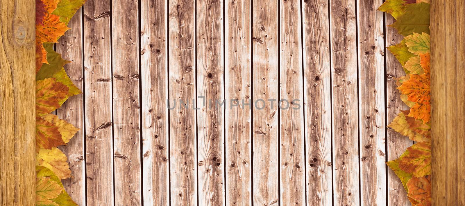 Autumn leaves pattern against wooden planks background