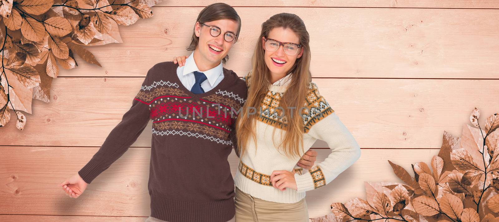 Happy geeky hipster couple embracing against overhead of wooden planks