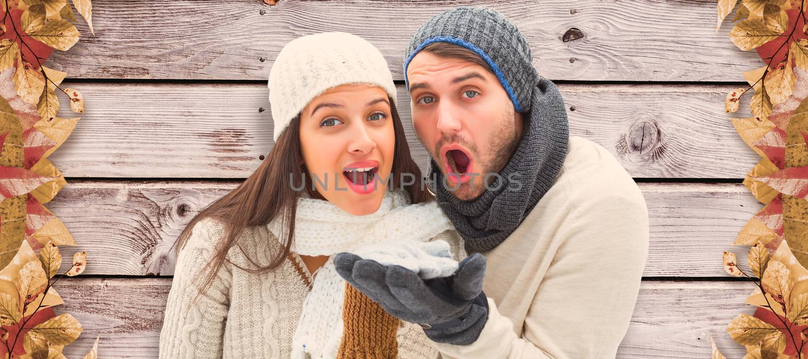 Young winter couple against digitally generated grey wooden planks