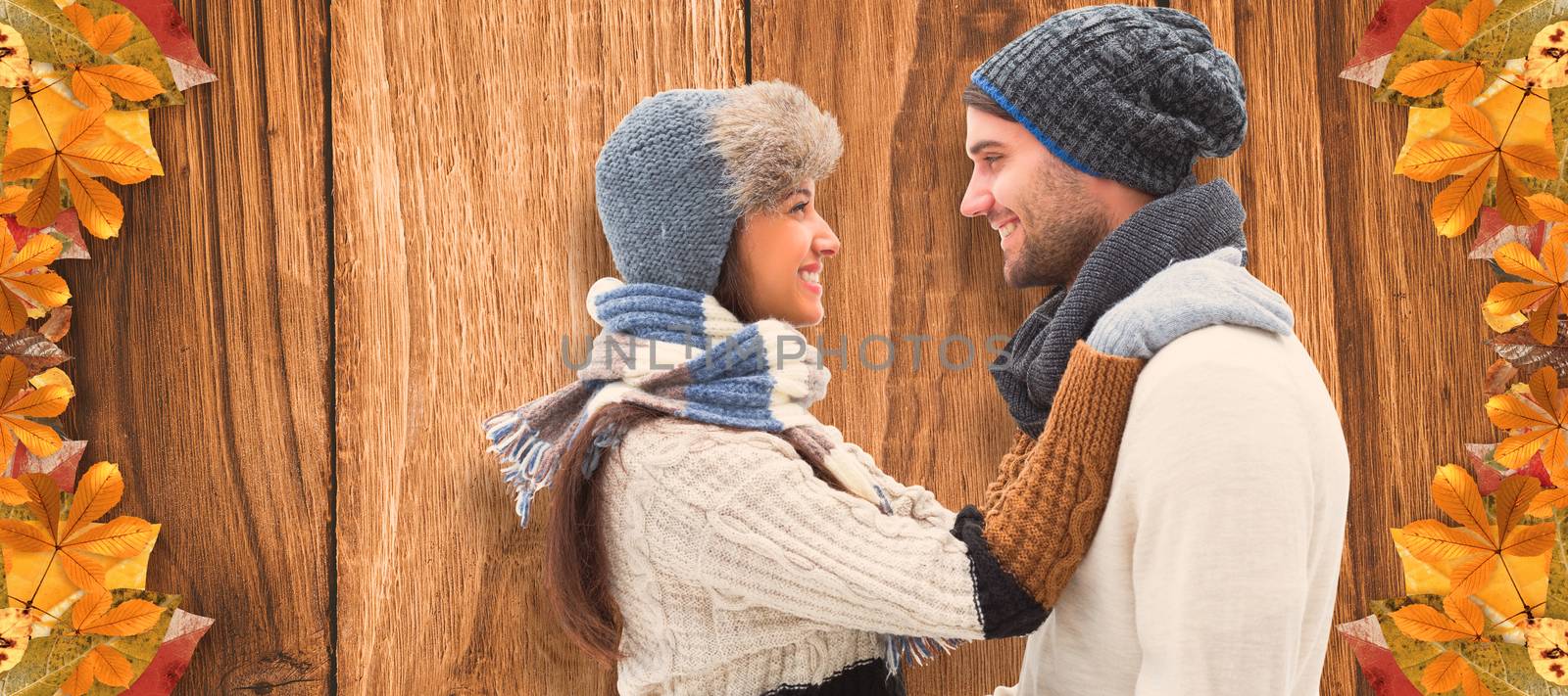 Young winter couple against wooden table