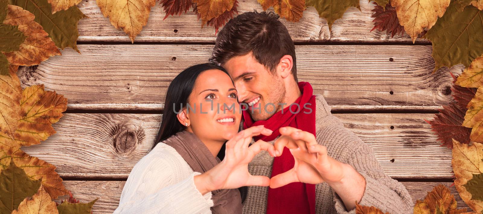 Composite image of young couple making heart with hands by Wavebreakmedia