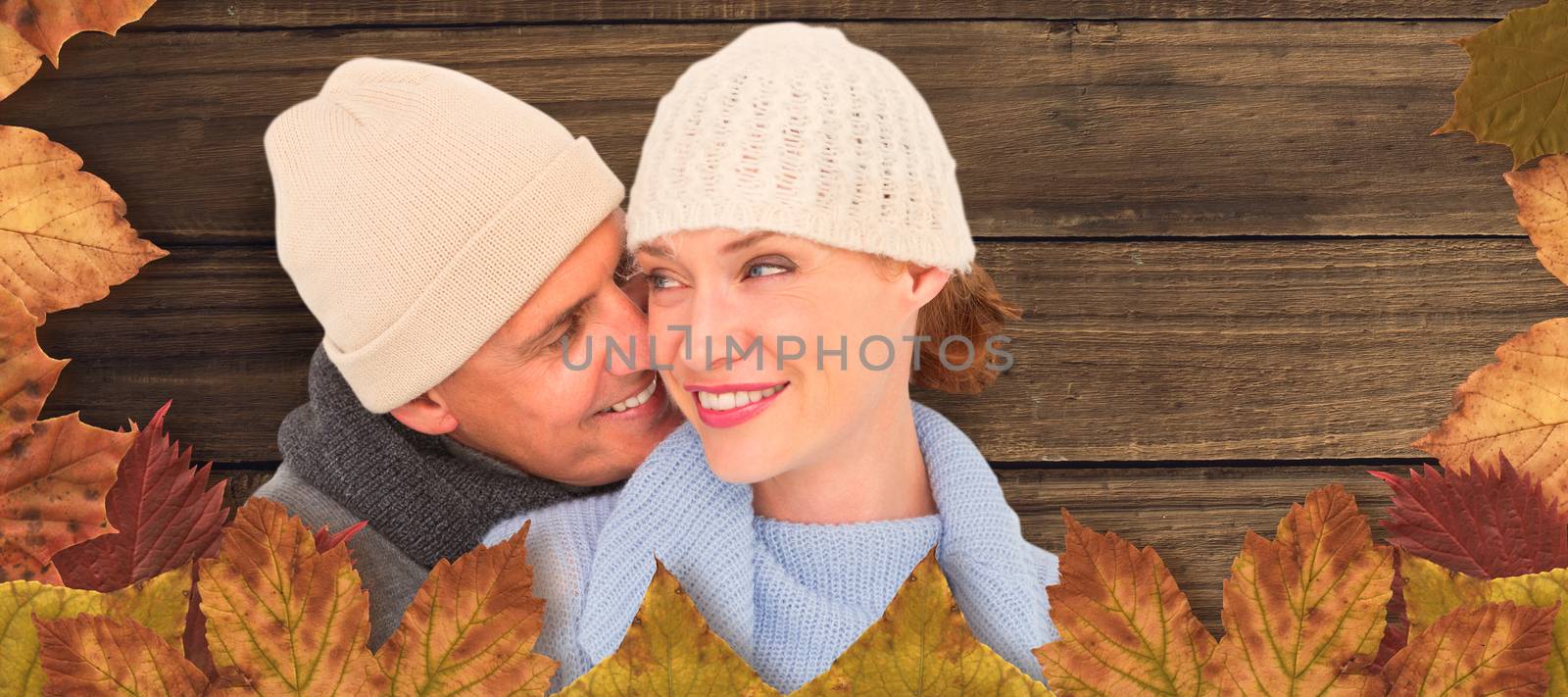 Casual couple in warm clothing against overhead of wooden planks