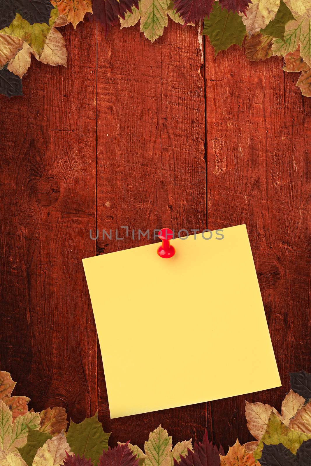Illustrative image of pushpin on yellow paper  against autumn leaves pattern