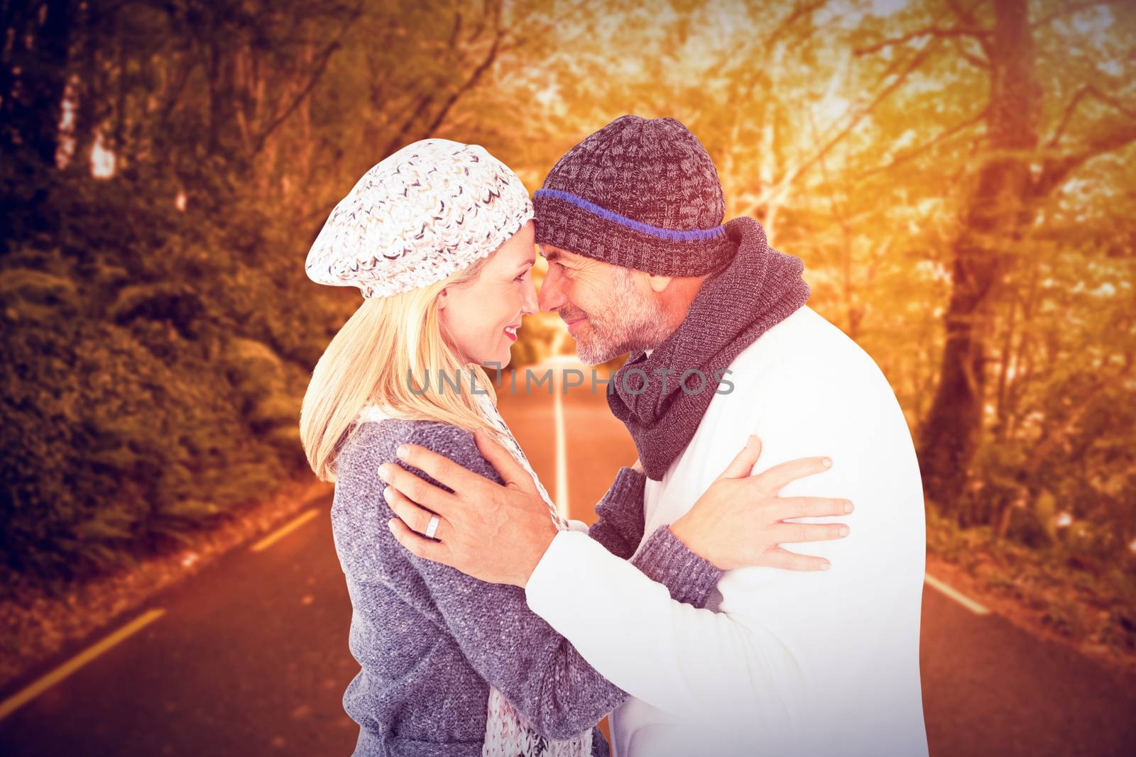 Smiling cute couple romancing over white background against country road