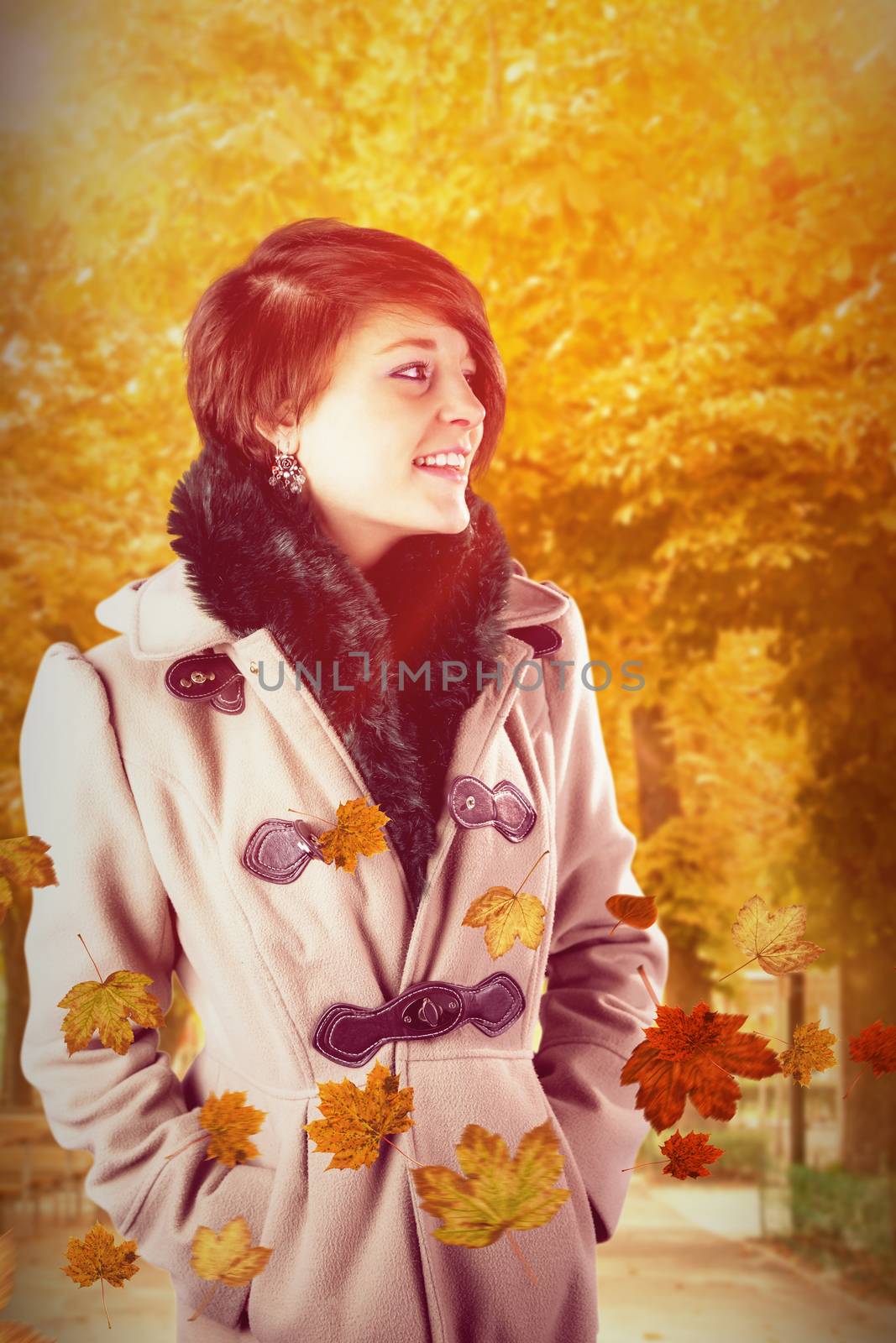 Smiling beautiful woman in winter coat against autumn scene