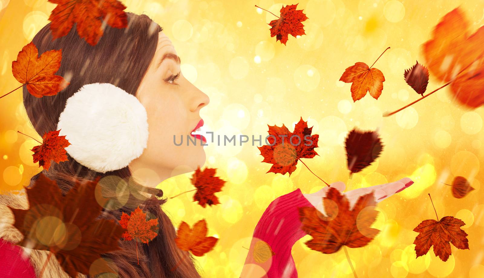 Brunette in winter clothes with hand out against yellow abstract light spot design