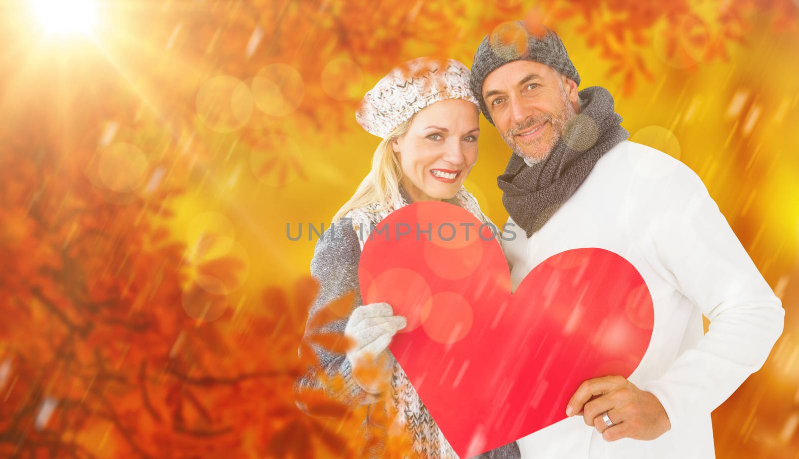Composite image of portrait of happy couple holding heart by Wavebreakmedia