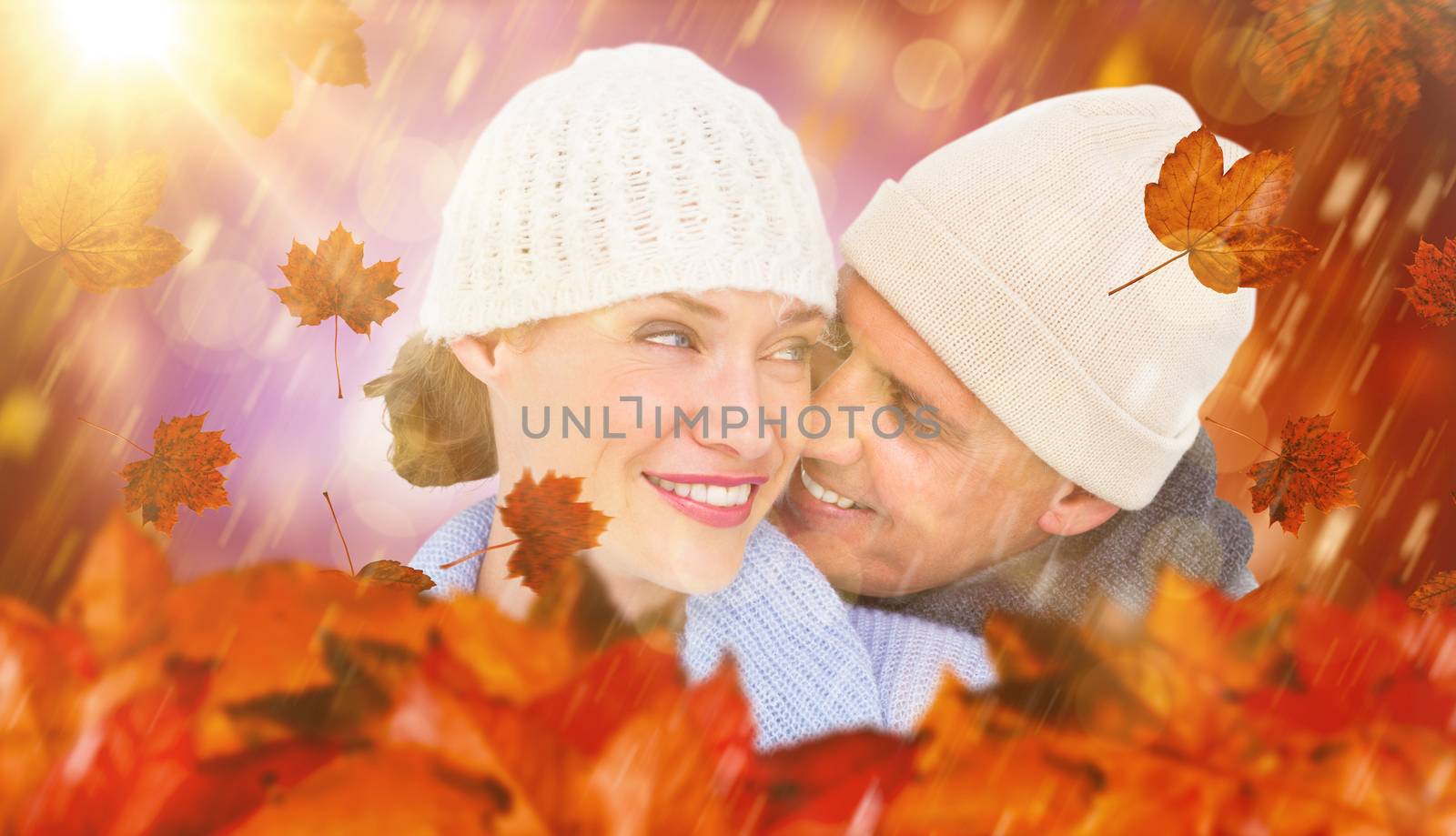 Casual couple in warm clothing against dark abstract light spot design