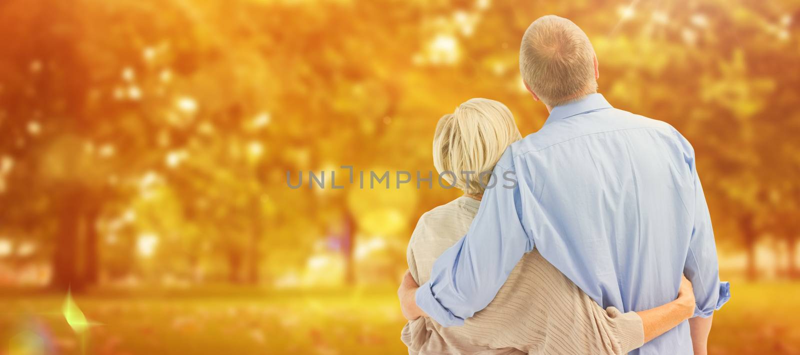 Composite image of mature couple hugging and looking by Wavebreakmedia