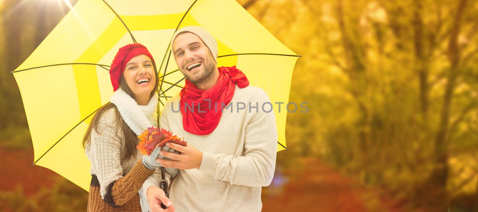 Composite image of autumn couple holding umbrella by Wavebreakmedia