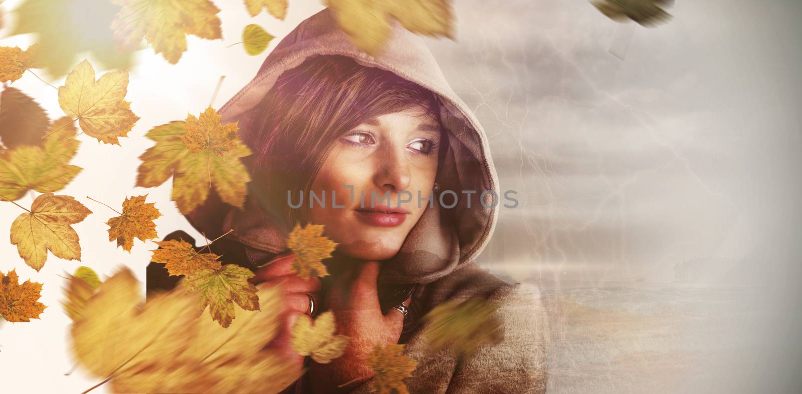 Beautiful woman wearing winter coat looking away against autumn leaves