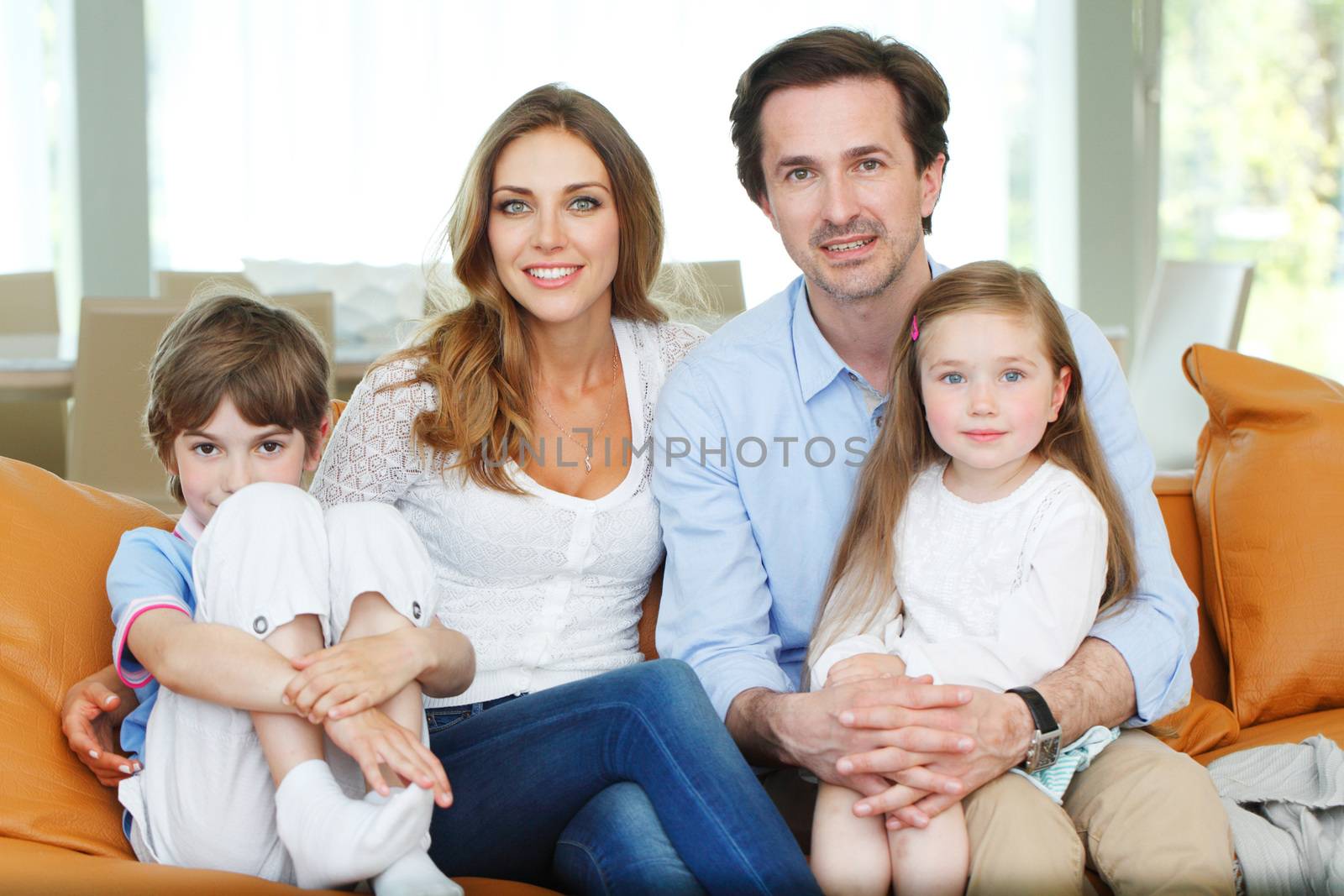 portrait of happy family sitting on the couch