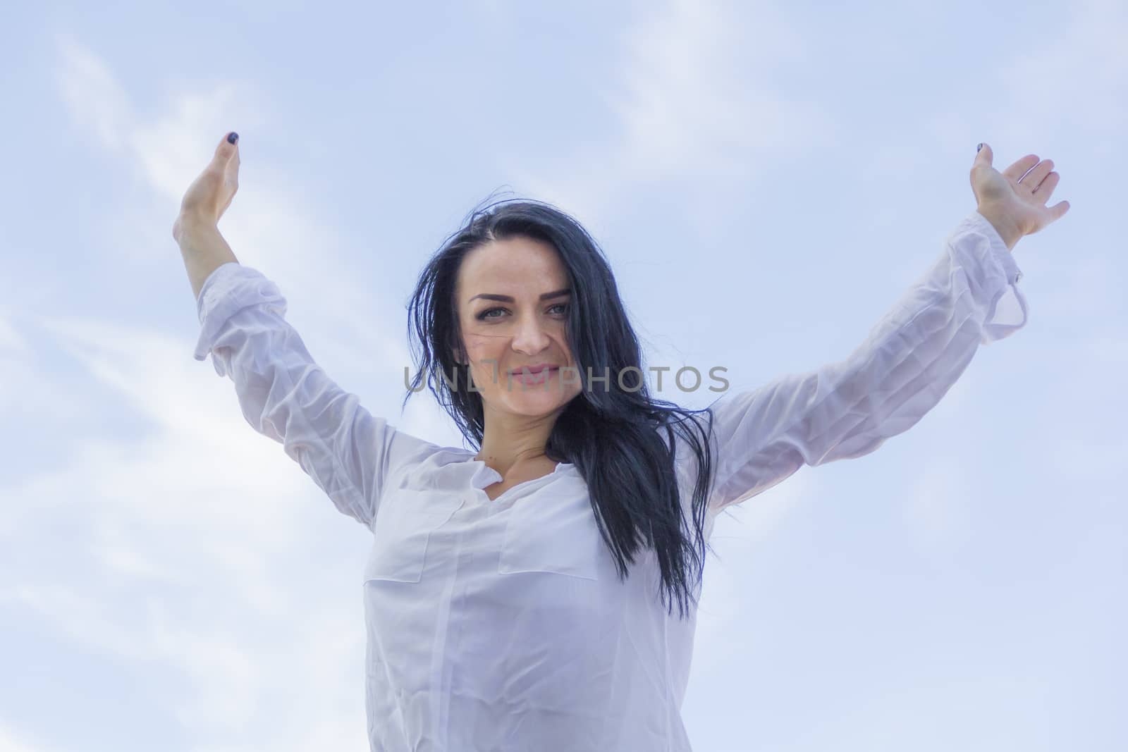 Photo of brunette woman with upward hands
