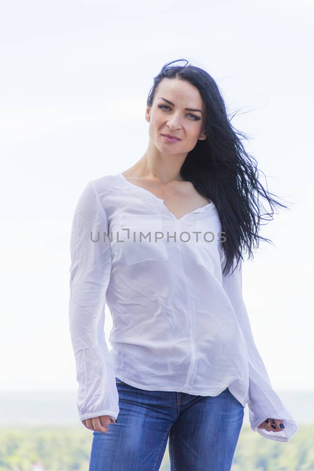 Photo of Caucasian brunette woman in white