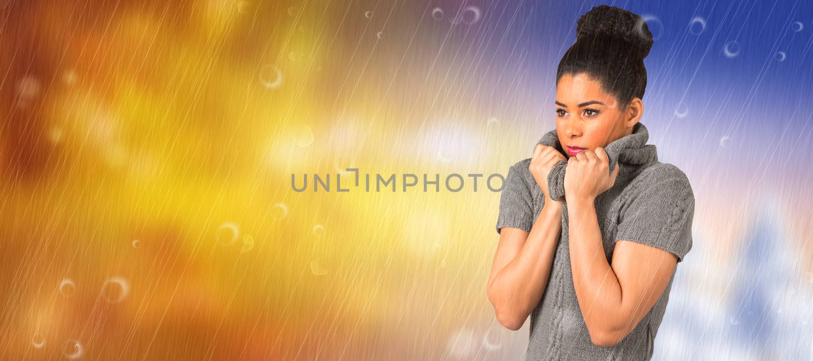 Composite image of pretty girl in winter jumper shivering by Wavebreakmedia