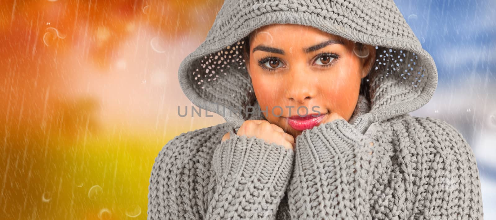 Composite image of pretty girl in winter jumper looking at camera by Wavebreakmedia