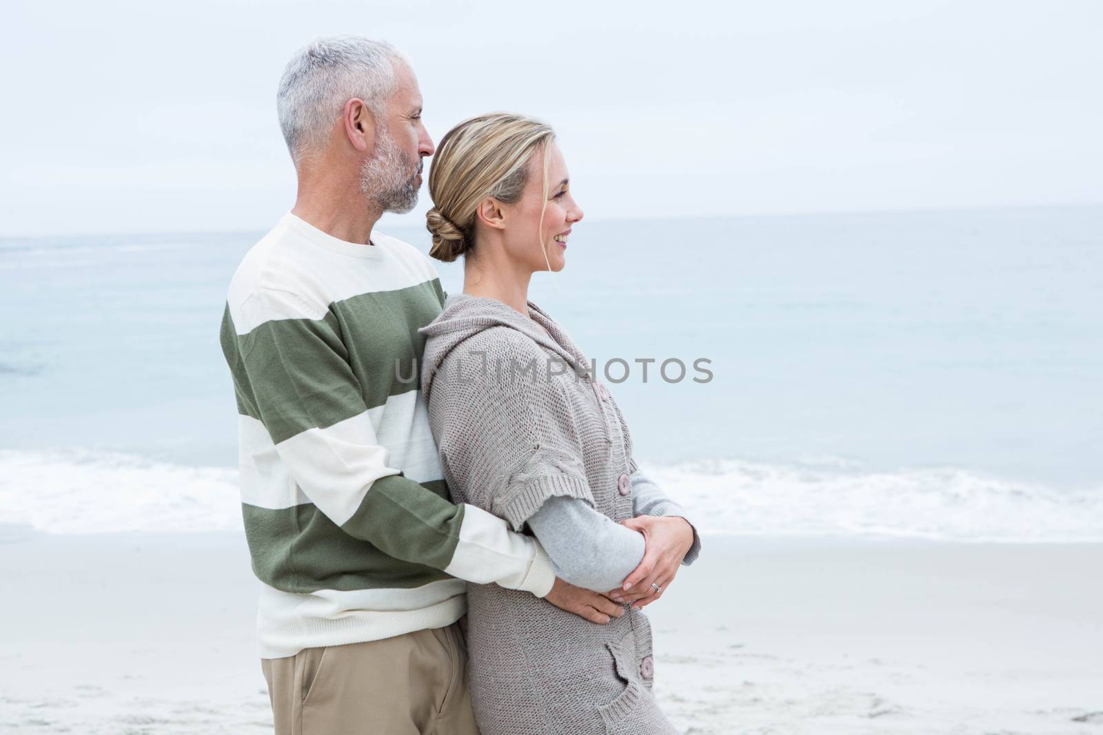 Romantic couple hugging each other at the beach