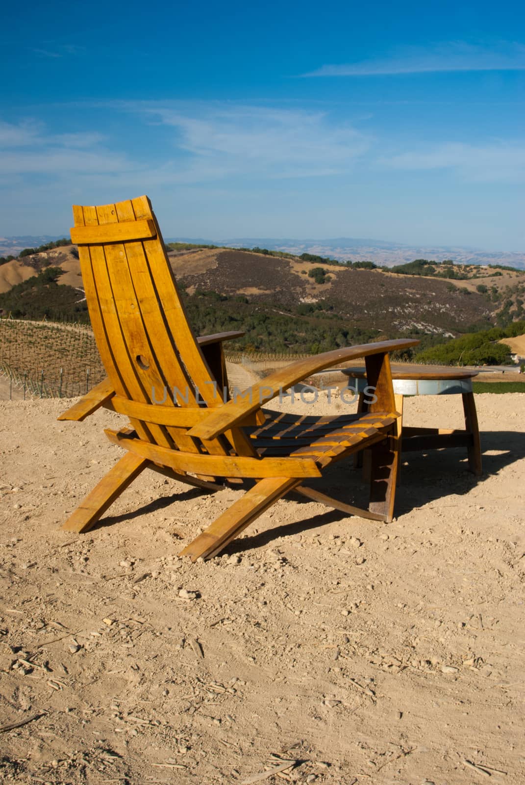 Chair and table overlooking vineyards of California by emattil